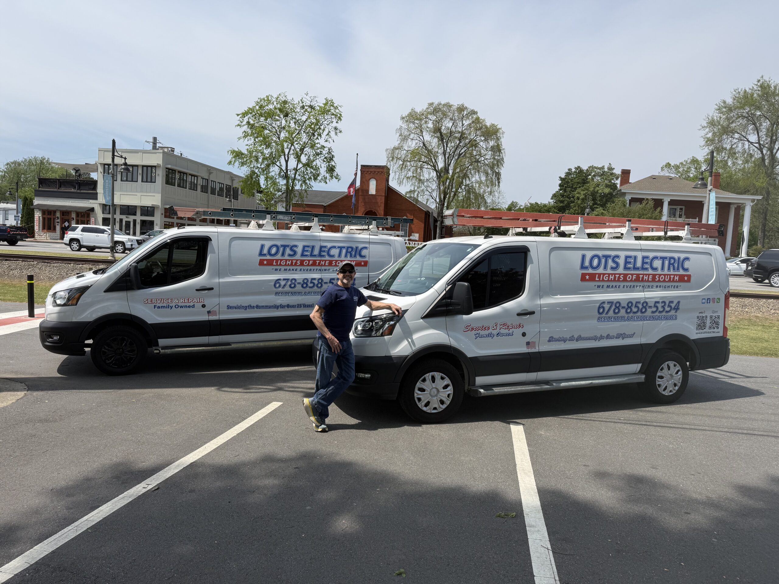 Steve, owner of LOTS Electric, standing by work van